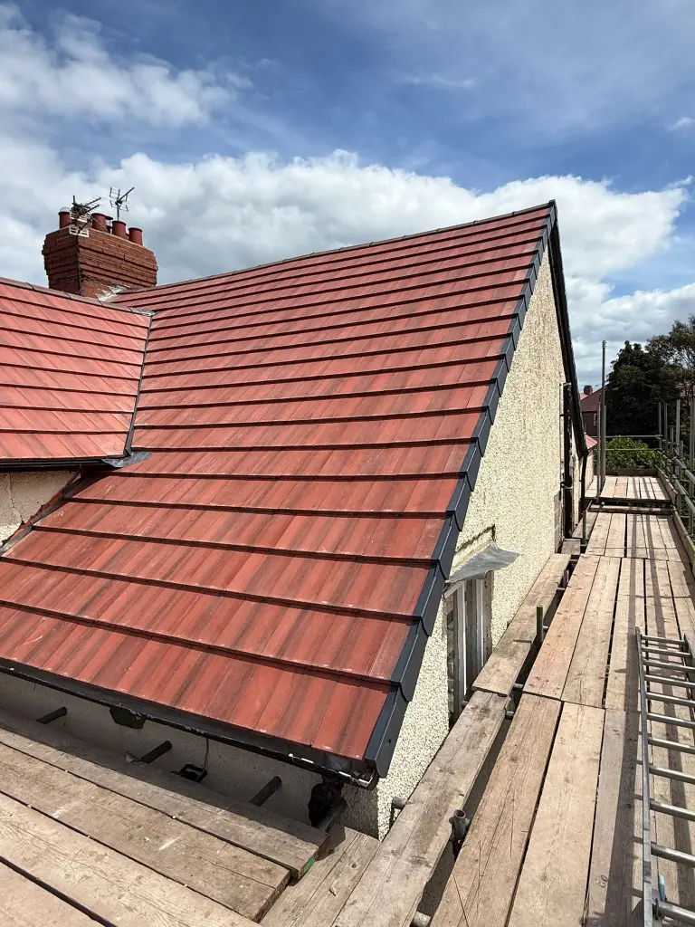 Tiled roof repaired from scaffolding